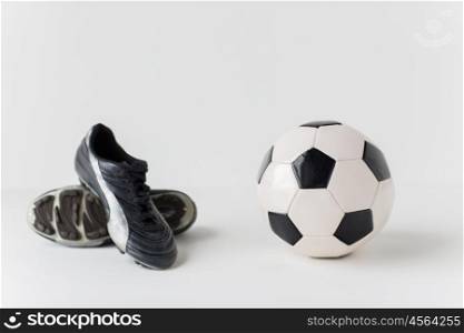 sport, soccer, football and sports equipment concept - close up of ball and boots