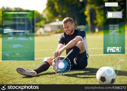 sport, sports injury and people concept - injured soccer player with ball on football field. injured soccer player with ball on football field