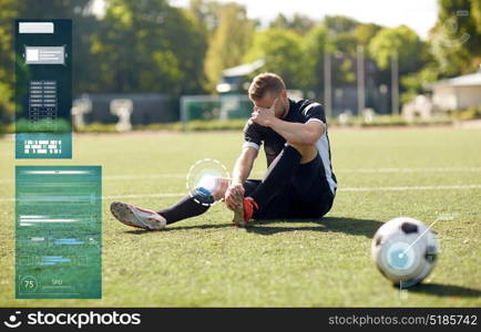 sport, sports injury and people - injured soccer player with ball on football field. injured soccer player with ball on football field