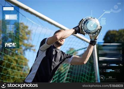 sport, technology and people concept - soccer player or goalkeeper catching ball at goal on football field. goalkeeper with ball at football goal on field
