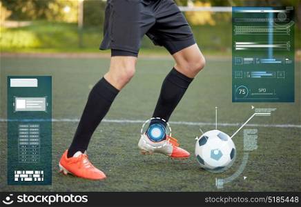 sport, technology and people concept - soccer player playing with ball on football field. soccer player playing with ball on football field