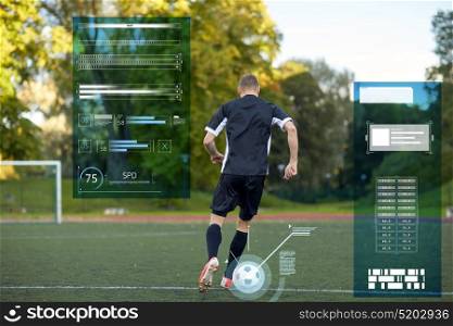 sport, technology and people concept - soccer player playing with ball on football field. soccer player playing with ball on football field