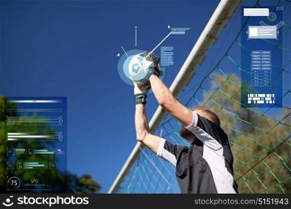 sport, technology and people - soccer player or goalkeeper catching ball at football goal on field. goalkeeper with ball at football goal on field