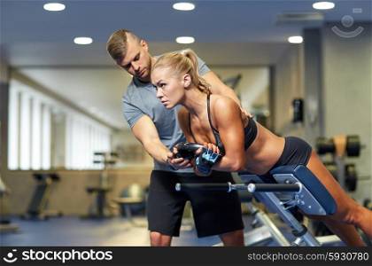 sport, training, fitness, lifestyle and people concept - young woman with personal trainer flexing back and abdominal muscles on bench in gym