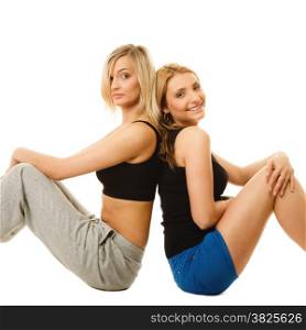 Sport training gym and lifestyle concept. Two young sporty women after workout, isolated on white