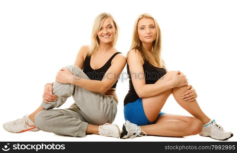 Sport training gym and lifestyle concept. Two young sporty women after workout, isolated on white