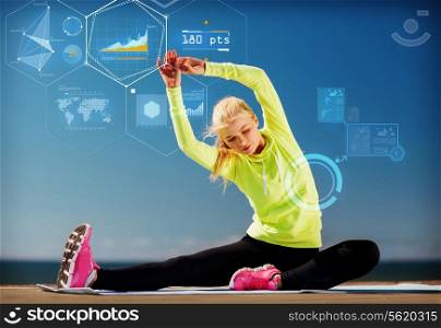 sport, training, technology and lifestyle concept - young woman exercising outdoors