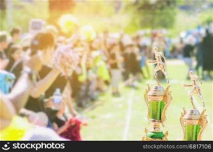 Sport trophy over blur crowded people in school sport day festival