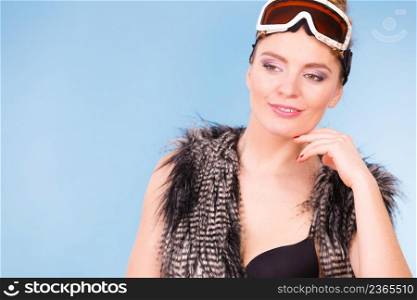 Sport, winter, recreation concept. Young woman with goggle. Lady wearing fur and warm vest.. Young woman with goggle.
