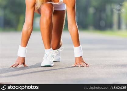 Sport woman. Bottom view of young sport woman in start pose