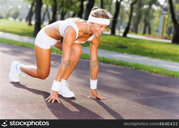 Sport woman. Bottom view of young sport woman in start pose