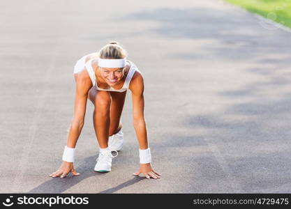 Sport woman. Bottom view of young sport woman in start pose