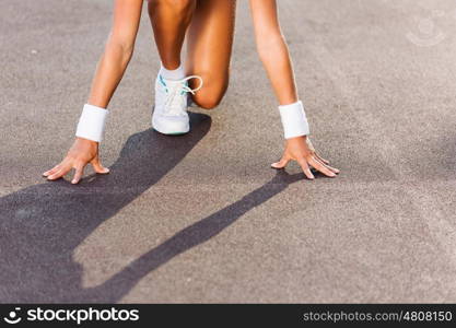 Sport woman. Bottom view of young sport woman in start pose