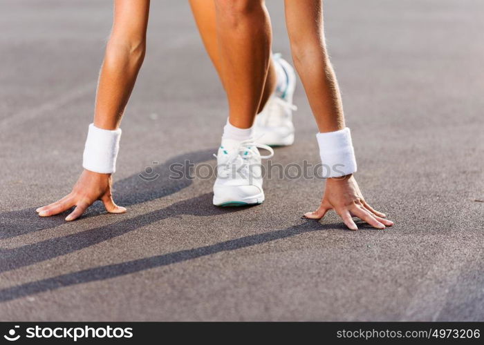 Sport woman. Bottom view of young sport woman in start pose