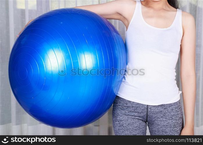 sport woman doing yoga exercise with fitness ball