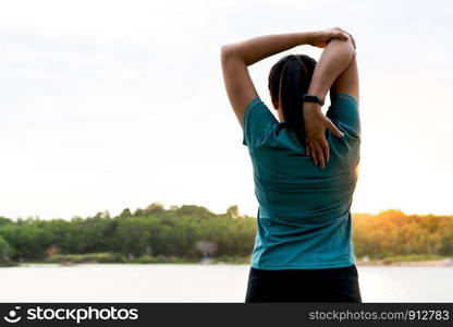 sport woman is stretching muscle after workout