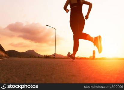 sport woman running on a road. Fitness woman training at sunset