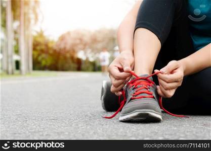 sport woman tying shoelace before running, outdoor activities