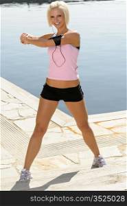 Sport young woman stretch body by pier marina sunny day