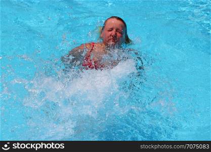 Sportive concept. Happy girl. Young woman enjoying summer vacations. Sportwoman swimming in pool. Girl diving into transparent water of pool. Sportive concept. Happy girl. Young woman enjoying summer vacations.