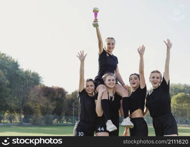 sportive girls winning trophy