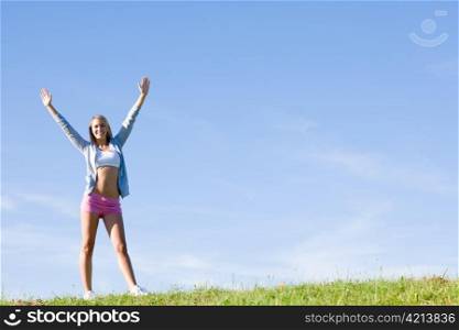 Sportive stretching young happy woman meadows blue summer sky