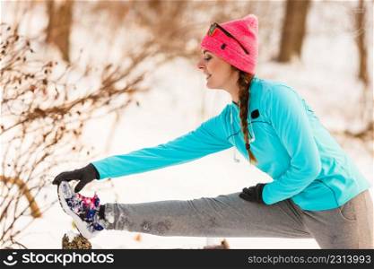 Sports and activities in winter time. Slim fit fitness woman outdoor. Athlete girl training wearing warm sporty clothes outside in cold snow weather.. Female fitness sport model outdoor in cold winter weather