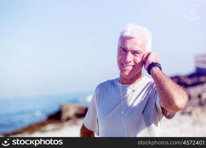 Sports and music. man getting ready for jogging. Sports and music. man getting ready for jogging and listening to the MP3 player