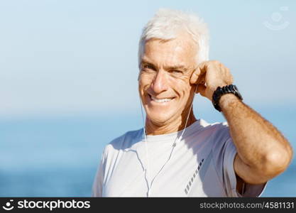 Sports and music. man getting ready for jogging. Sports and music. man getting ready for jogging and listening to the MP3 player