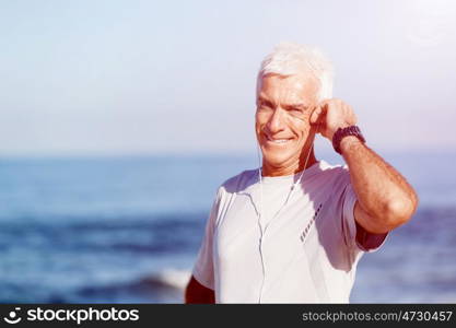 Sports and music. man getting ready for jogging. Sports and music. man getting ready for jogging and listening to the MP3 player