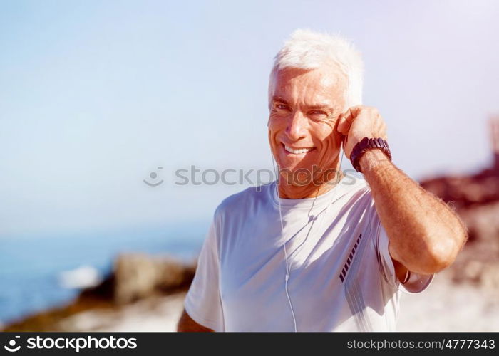 Sports and music. man getting ready for jogging. Sports and music. man getting ready for jogging and listening to the MP3 player