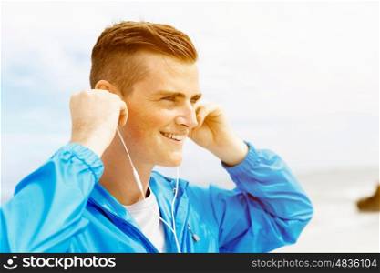 Sports and music. man getting ready for jogging. Sports and music. man getting ready for jogging and listening to the MP3 player