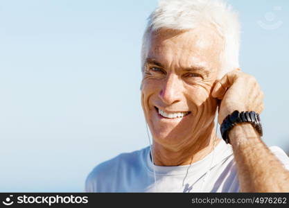 Sports and music. man getting ready for jogging. Sports and music. man getting ready for jogging and listening to the MP3 player