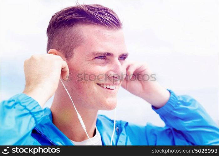 Sports and music. man getting ready for jogging. Sports and music. man getting ready for jogging and listening to the MP3 player