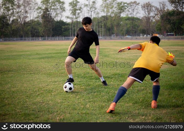 Sports and recreation concept two male soccer players attending regular practice sessions and memorizing attack and defense patterns.