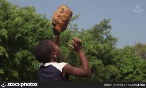 Sports and young people, portrait of happy black child playing baseball in city park