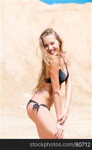 sports beautiful woman in bikini beautifully smiling, portrait on the beach