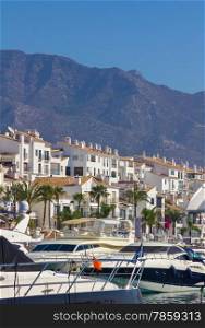 sports boats and yachts with the city of Puerto Banus in the background, in Malaga, Spain