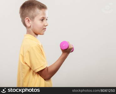 Sports boy making exercise with dumbbell. Care about health and body