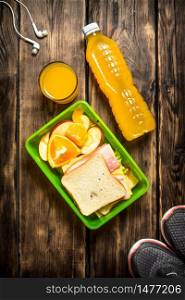 Sports Breakfast. Sneakers, headphones and orange juice. Sneakers, headphones, orange juice , sandwiches and fruit.