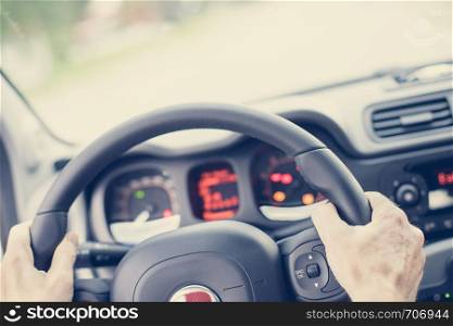 Sports car steering wheel, male hands steering