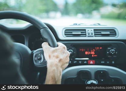 Sports car steering wheel, male hands steering