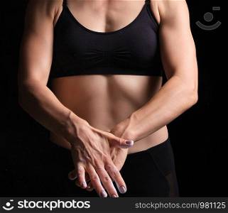 sports hands with veins of a young girl, she rubs white magnesia into her skin, low key