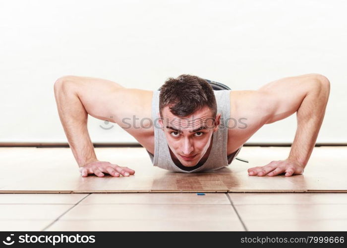 Sports man making pushups,. Care about health and body