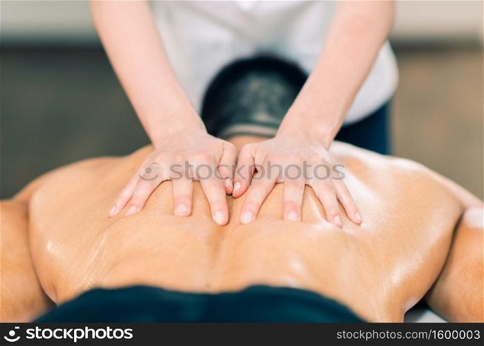 Sports massage. Therapist massaging sportsman?s back