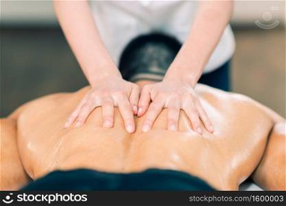 Sports massage. Therapist massaging sportsman?s back