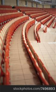 sports tribunes. Empty colored chairs at the stadium
