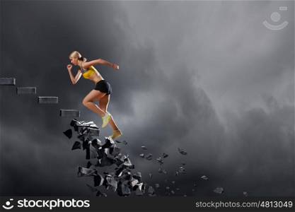Sports woman overcoming challenges. Sports active woman running on stone collapsing ladder