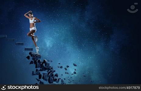 Sports woman overcoming challenges. Sports active woman running on stone collapsing ladder