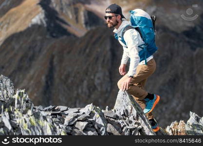 Sportsman among mountain boulders